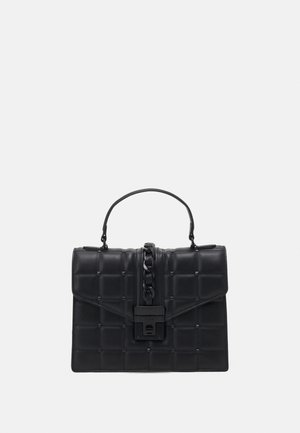 Black leather handbag with quilted square pattern, top handle, central chain detail, and front turn-lock closure.