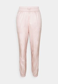 Ljust rosa träningsbyxor med elastiskt midjeband och muddar. Tillverkade av glänsande, slät tyg och har en liten logotyp på vänster sida.