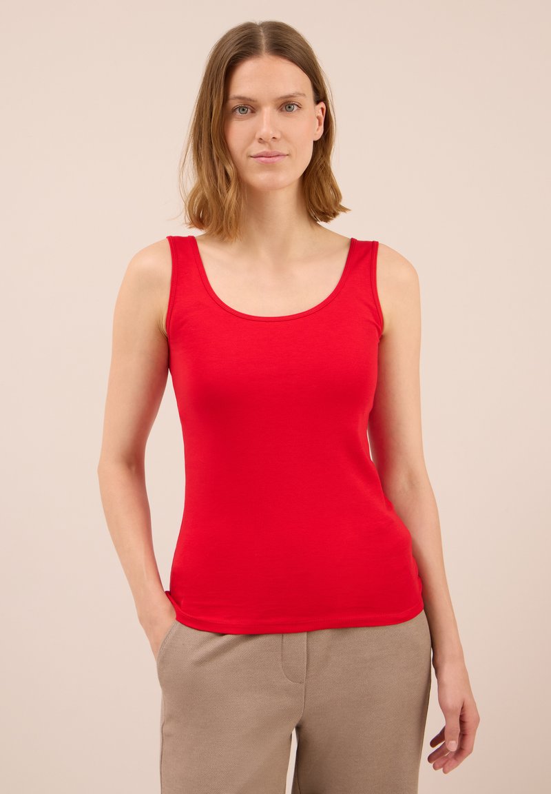 Canotta rossa senza maniche in morbido cotone con una silhouette aderente. Il design minimalista presenta un colletto rotondo e una texture liscia.