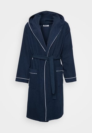 Marineblå hættebadekåbe lavet af frotté, med hvid piping, bånd i taljen og to forlommer. Blød tekstur, knæ-længde design.