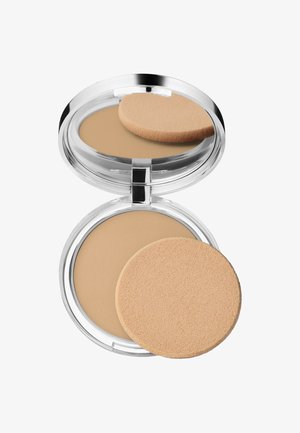 Poudre compacte dans un contenant rond transparent avec une surface beige lisse. Inclut une éponge applicatrice ronde et douce positionnée à côté.