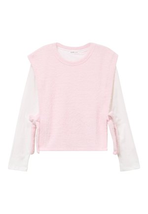 Pink textured sweater with short sleeves, layered over a white long-sleeve shirt. Features ties at the sides for adjustment.