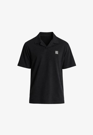 Polo noir à manches courtes avec un petit logo carré blanc sur la poitrine gauche et un col classique.