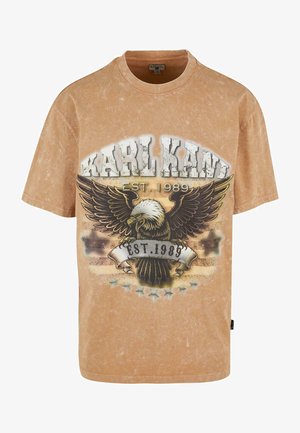 Brown vintage T-shirt featuring a graphic with an eagle and "KARL KANI EST. 1989" text. Soft, textured fabric with a loose fit.