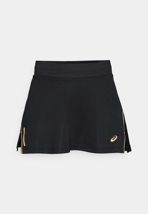 Black athletic skirt made from soft, stretchy fabric. Features a wide waistband, side zippers, and a gold logo on the lower right.