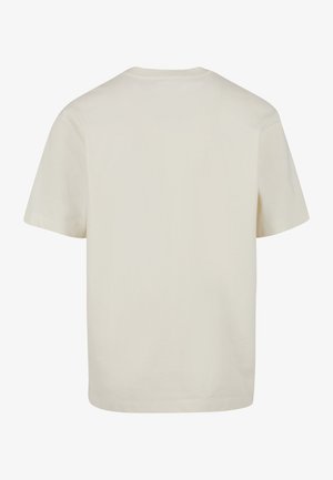 Maglietta beige semplice a maniche corte vista da dietro con scollo rotondo e vestibilità morbida.