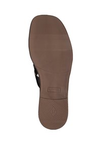 Semelle de chaussure en caoutchouc marron avec un motif de grip texturé, une finition lisse et un logo en relief ; taille indiquée comme 37.