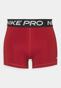 Pantalones cortos deportivos rojos hechos de material elástico. Presentan una cinturilla negra con "NIKE PRO" en letras blancas y un pequeño logo blanco en el lado inferior.
