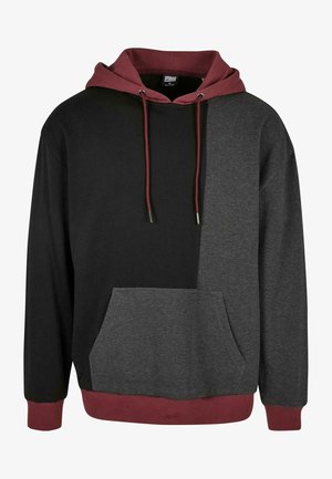 Kapucnis pulóver fekete és szürke színblokk mintával, bordó bordázott mandzsettákkal és zsebbel, puha anyagból készült.