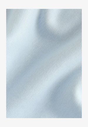 Heledsinine kangas, millel on tekstureeritud, laineline muster. Pind on sile ja veidi elastne, näidates pehmet viimistlust.