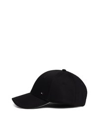 Black baseball cap with a curved visor, made of fabric, featuring a small logo patch on the front and eyelets for ventilation.