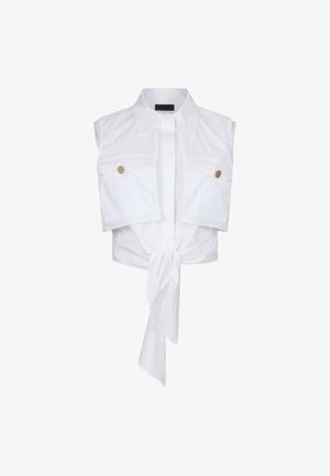 Witte cropped tanktop gemaakt van katoen, met korte mouwen, twee zakken aan de voorkant, gouden knoopaccenten en een gestrikt zoomdetail.