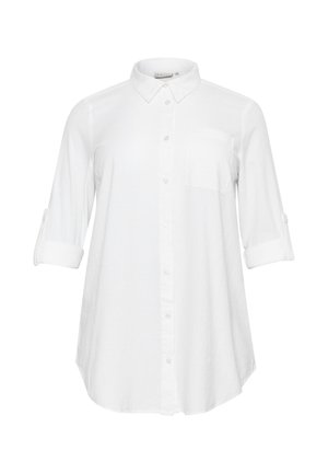 Fehér hosszú ujjú ing, gombolós, hegyes gallérral, mellzsebbel és felhajtott ujjakkal, melyeket gombos pántok rögzítenek.