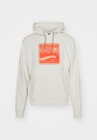 Hoodie beige clair, avec un motif à l'avant en orange vif, capuche à cordon, poche kangourou, et poignets et ourlet côtelés.