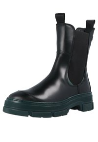 Black leather Chelsea boots with elastic side panels, chunky green rubber soles, and pull tabs for easy wear. Smooth finish, rounded toe.