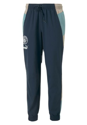 Dunkelblaue Sweatpants mit elastischem Bund und Kordelzug, ausgestattet mit hellblauen und beigen Einsätzen sowie den Logos von Manchester City und Puma.