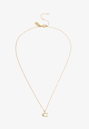 Collar delicado de cadena dorada con un pequeño colgante en forma de herradura y un cierre ajustable con una etiqueta.