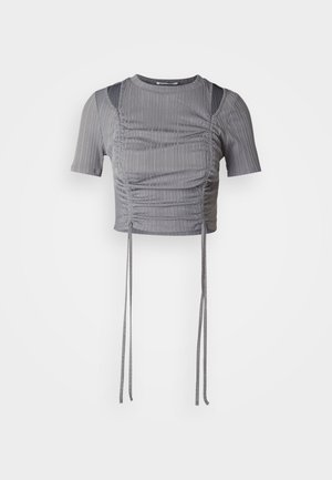 Gray cropped top with short sleeves, featuring vertical ribbing, gathered detailing, and adjustable ties at the hem for a tailored fit.