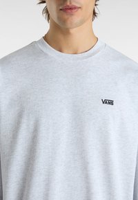 Light grey long-sleeve t-shirt made of cotton, featuring a crew neck and a small black "VANS" logo on the upper left side.