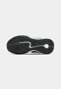 Black sneaker outsole with textured grip pattern, featuring a white curved logo and a smooth black edge along the sole.