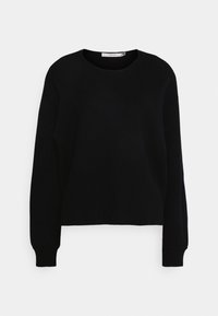 Pull noir à manches longues avec un col rond. Tissu en tricot texturé et poignets côtelés. Design court qui offre une coupe décontractée.