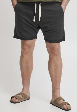Shorts negri din bumbac cu talie elastică și șnur, margine răsucită și branding subtil. Purtați cu sandale din suede maro cu un design cu două curele.