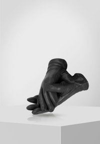 Black leather gloves with a soft finish, featuring a snug fit and stitched accents, positioned together on a white surface.