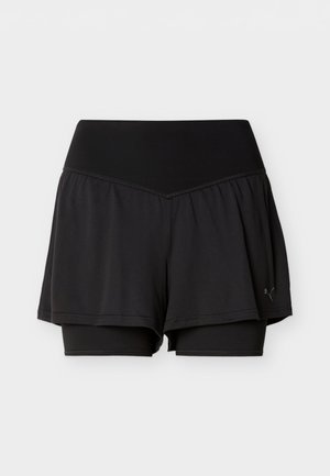 Svarte lagdelte treningsshorts med tettsittende innerlag og løstsittende yttersjikt, med bredt midjebånd og liten Puma-logo på siden.
