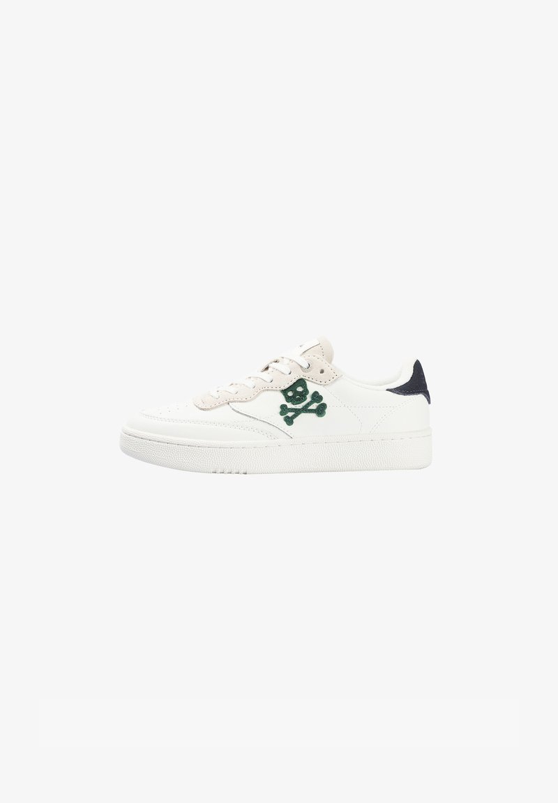 White low-top sneaker with beige accents, green skull and crossbones logo on side, and black heel tab.