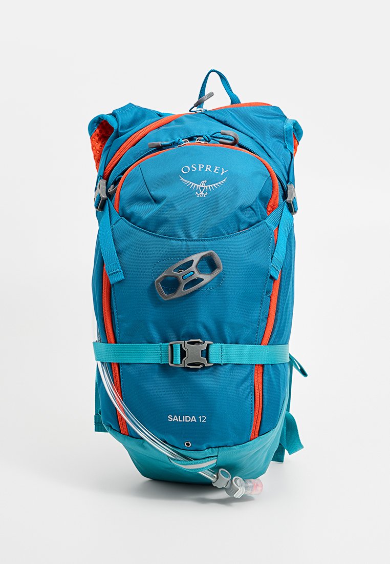 Turkusowy i pomarańczowy plecak Osprey Salida 12, wyposażony w zamki błyskawiczne, regulowane paski, wąż do nawodnienia oraz wzorzystą, trwałą tkaninę.