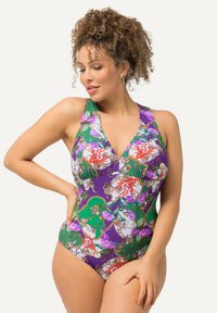 Maillot de bain avec un décolleté en V profond, des bretelles larges et un design vibrant avec des motifs violets, verts et floraux. Fabriqué en tissu extensible.