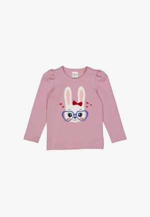Różowa koszulka z długim rękawem z grafiką królika w dużych okularach, czerwonej kokardzie i serduszkach; miękka bawełniana tkanina z marszczonymi szwami na ramionach.