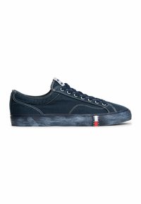 Low-top navy canvas sneaker with white stitching, navy laces, and a rubber sole featuring a small red, white, and blue logo tag.