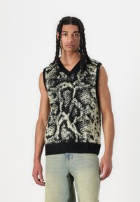 Gebreide mouwloze trui in groen en zwart met een gestructureerd abstract patroon, voorzien van een V-hals en een geribbelde zoom.
