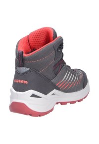 Stivale da trekking grigio con dettagli rossi, tessuto testurizzato, supporto alto alla caviglia e suola intermedia bianca. Presenta strisce laterali dinamiche per un interesse di design.