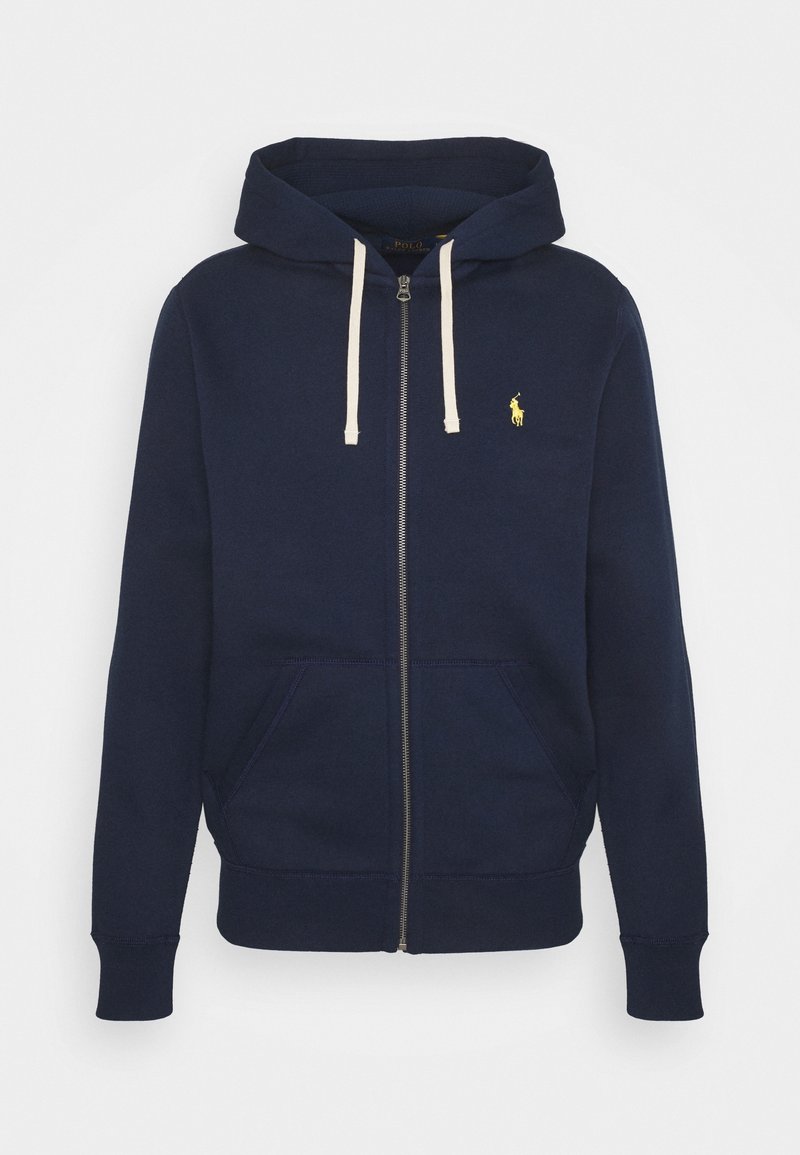 Marineblauwe zip-up hoodie van een katoenmix. Heeft een kangoeroezak, crèmekleurige aantrekkoorden en een klein geel logo op de linkerborst.