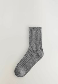 Hallgrey ribbed sokk, keskmise säärte pikkusega, valmistatud pehmest kudumifaasist. Omandab sujuva varbasauma ja kerge elastsuse ääres, et tagada mugav sobivus.