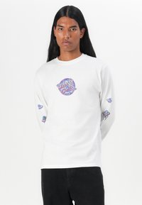 White long-sleeve T-shirt with colorful graphic print on the chest and sleeves. Features a round neck and a relaxed fit.