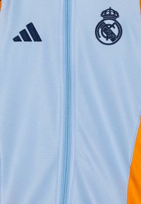 adidas Performance REAL MADRID 24/25 TRACK SUIT YOUTH UNISEX SET - Klubové oblečenie - glow blue/crew orange/team navy blue