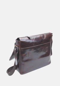 Brown leather messenger bag with a zip top, rectangular shape, front pocket, and adjustable fabric strap. Smooth texture, minimalistic design.