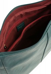 Borsa in pelle verde acqua con una texture liscia. L'interno presenta un rivestimento in tessuto bordeaux e due tasche con zip. Chiusura con zip superiore.