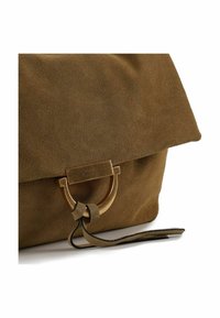 Bruine suède tas met een overslagontwerp, voorzien van een goudkleurige ronde sluiting en een leren riemdetail. Glad, gestructureerd oppervlak.