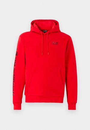 Red hooded sweatshirt made of soft fabric, featuring a front pocket. "EA7" logo on the chest and contrasting text down the left sleeve.