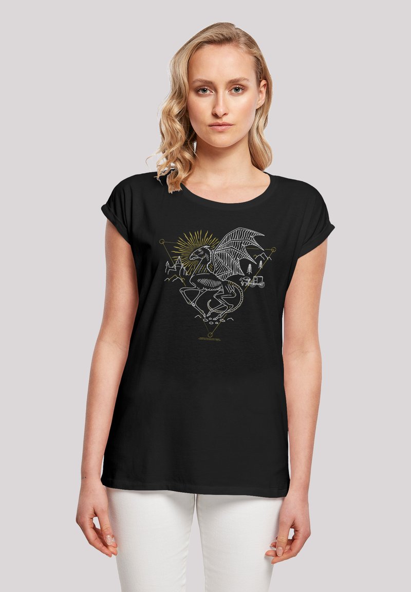 Black t-shirt with short sleeves featuring a white and gold graphic of a skeletal creature with wings and mountains, set against a dark background.