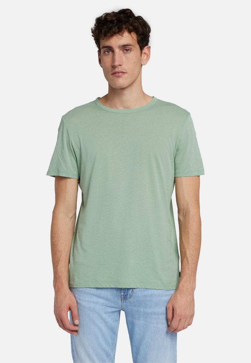 T-shirt a maniche corte, collo rotondo, in misto cotone di colore verde chiaro. Tessuto liscio, vestibilità comoda e design semplice senza fantasie o accenti.