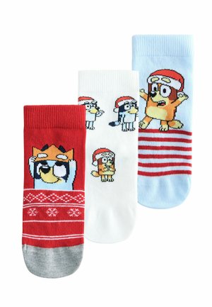 Three pairs of kids' socks: red with a pattern and character, white with character designs, and light blue with striped accents and character.
