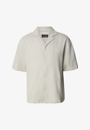 Svijetlosiva košulja kratkih rukava s rebrastom teksturom, otvorenim ovratnikom i kopčanjem na gumbe sprijeda. Na lijevoj strani nalazi se mali logo.