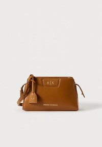 Brown leather handbag with a structured design. Features a detachable tag, embossed logo, and adjustable strap. Minimalist style, smooth texture.