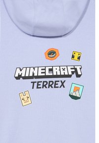 Világoslila kapucnis pulóver, rajta a "MINECRAFT TERREX" felirattal és négy pixeles ikon: iránytű, trófea, láma és hegyvidéki táj.