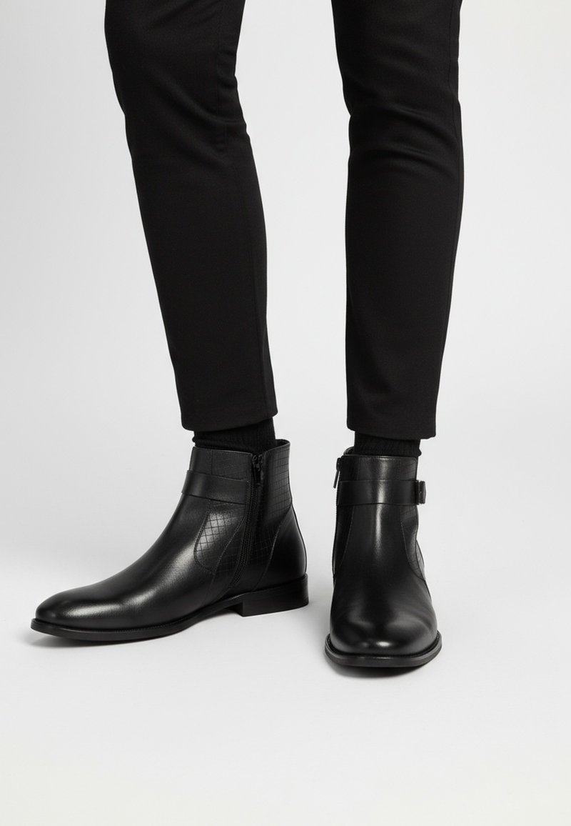 Bottes à cheville en cuir noir avec une finition lisse, un panneau latéral texturé et une fermeture éclair latérale. La semelle est plate et le design est élégant.